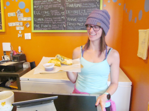 Chelsea Wahrendorf, owner of The Cutting Board in Oswego, gets ready to serve a breakfast burrito.